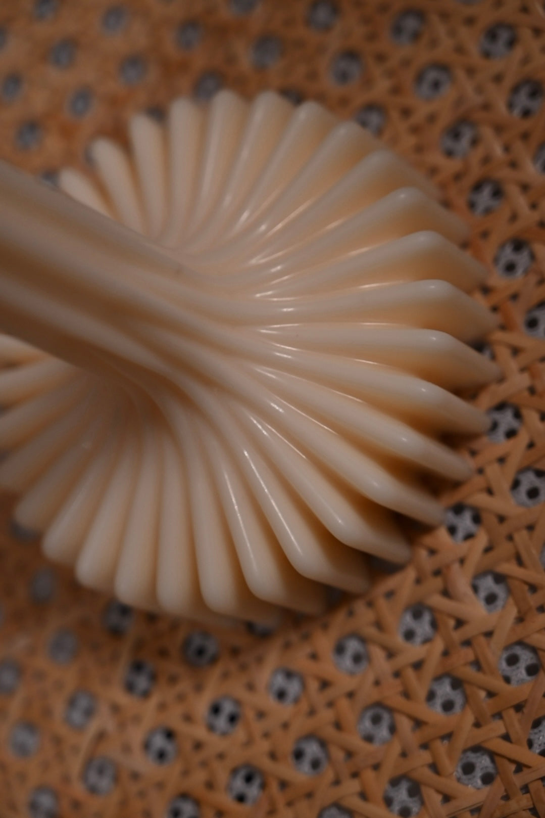Close up detail of fluted vase candle base showing sculptural ridged texture handcrafted from natural soy wax.