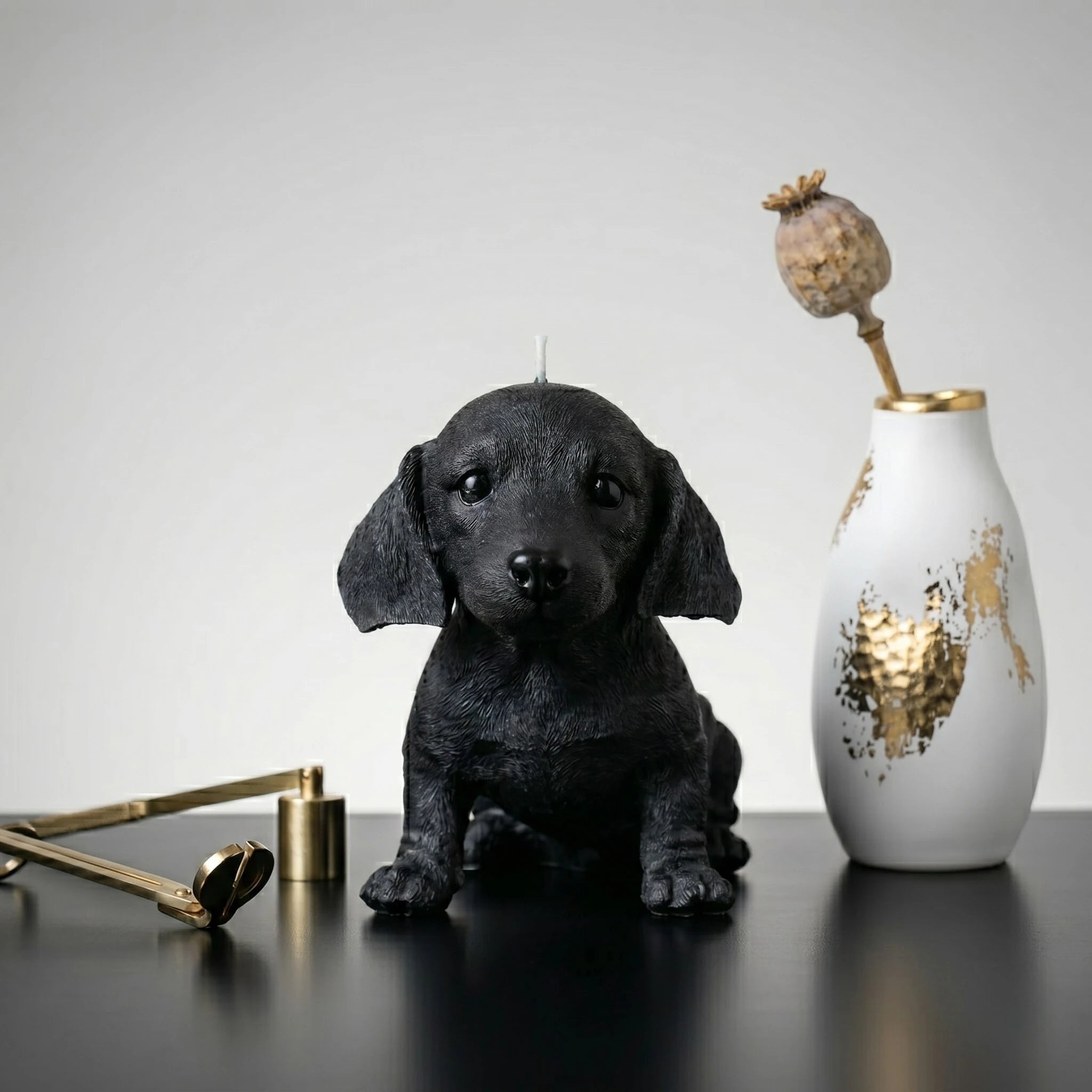 Black dachshund puppy candle handmade beeswax sculptural product shot