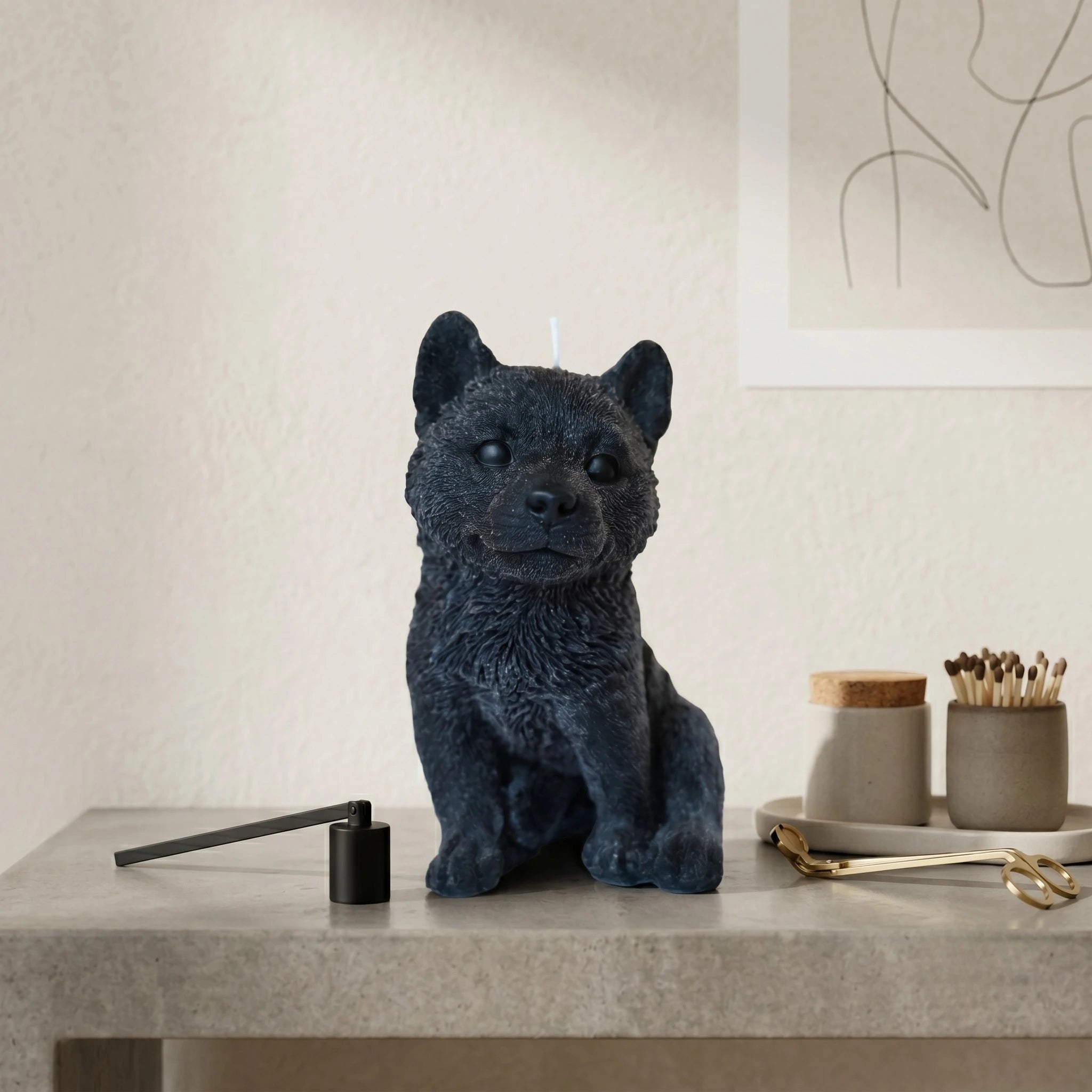 Charcoal husky puppy candle by House of Wick on a concrete surface, styled as modern home decor.