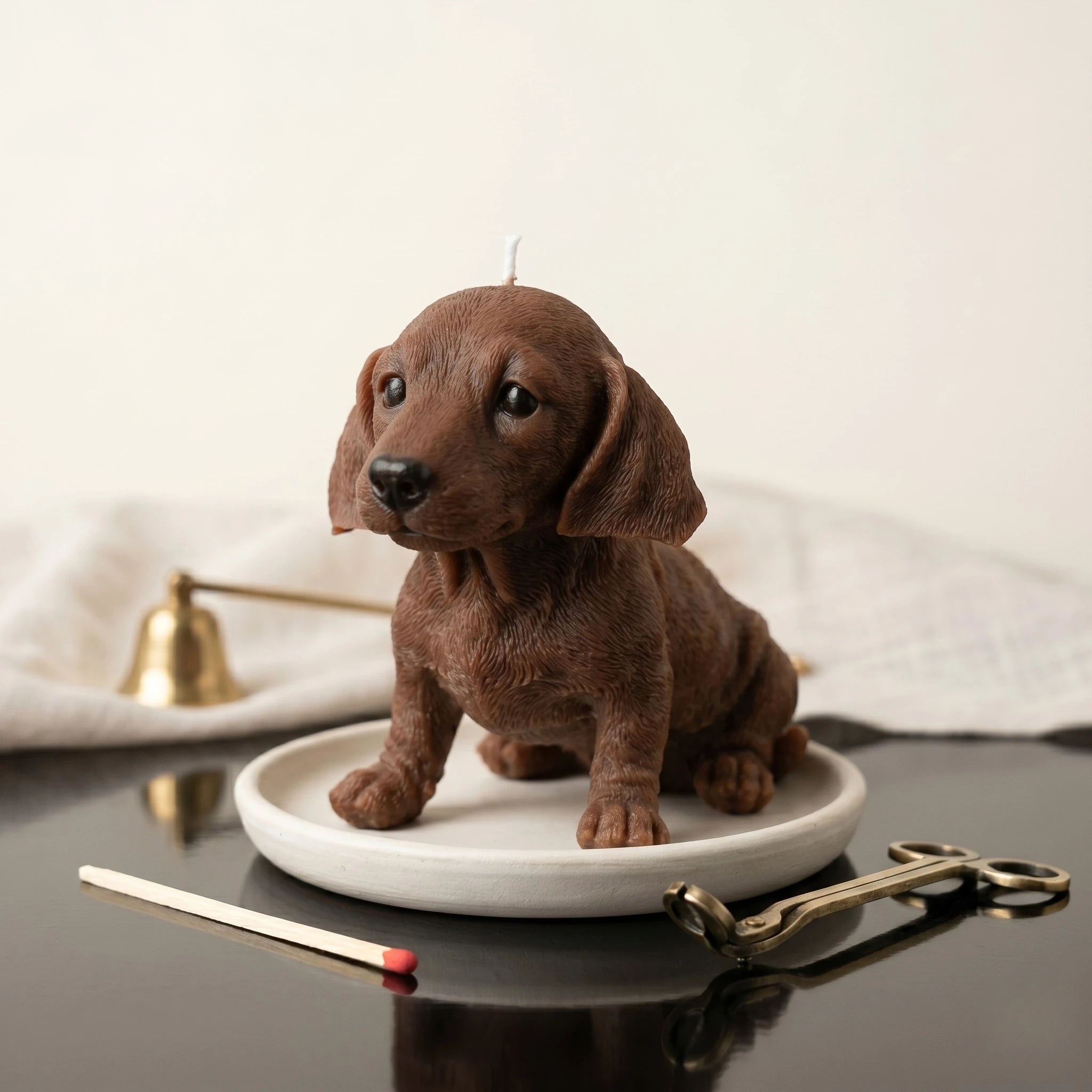 Chocolate dachshund puppy candle handmade beeswax sculptural product shot