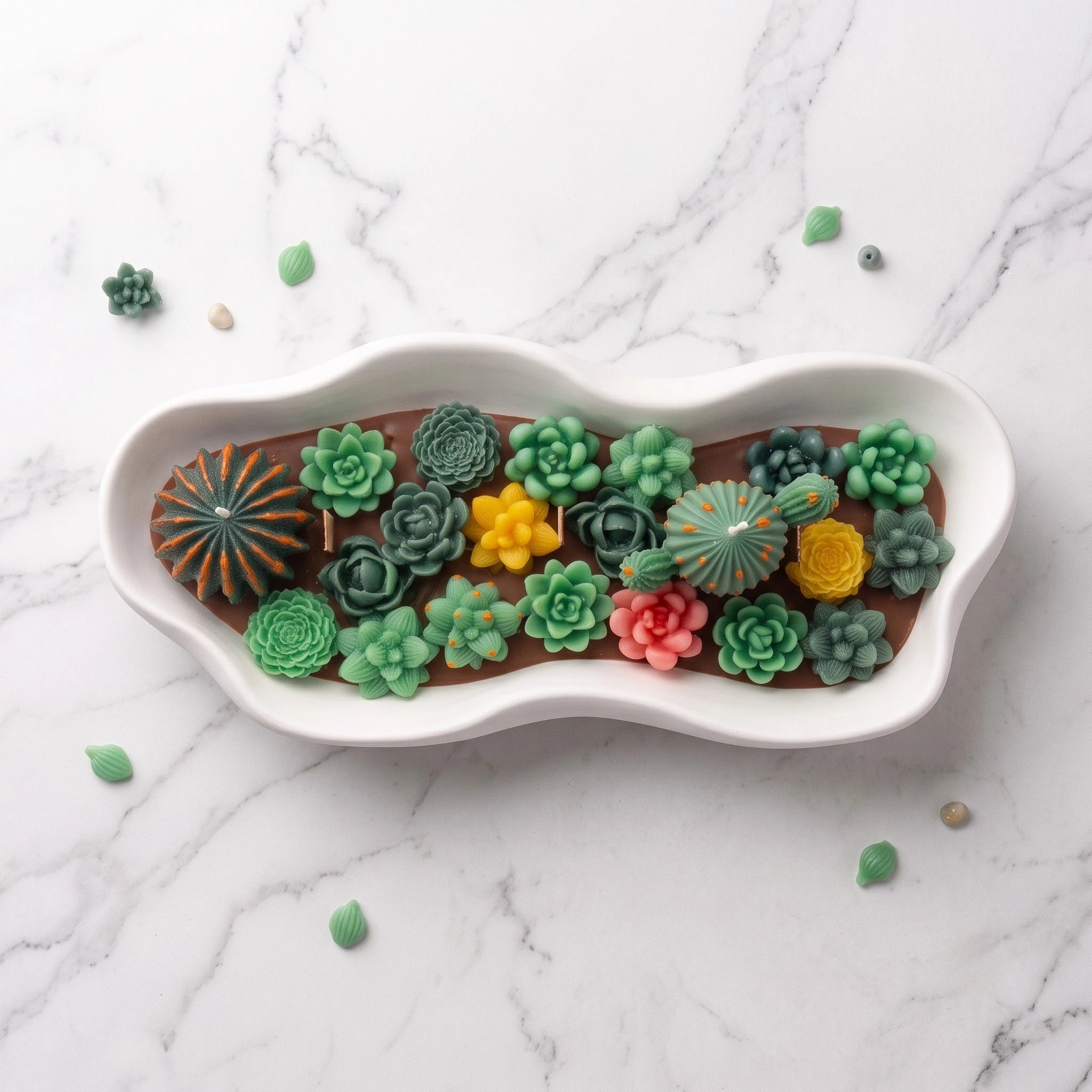 Overhead view of the House of Wick Desert Oasis candle showing succulent rosettes and a central cactus arranged in a white eco resin bowl