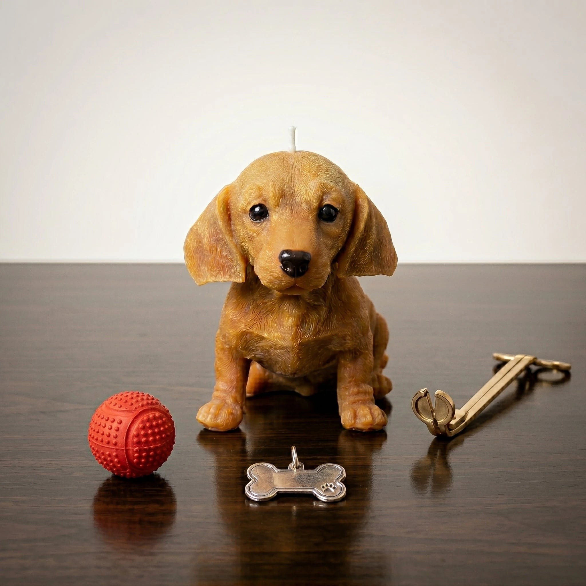 Golden dachshund puppy candle handmade beeswax sculptural product shot