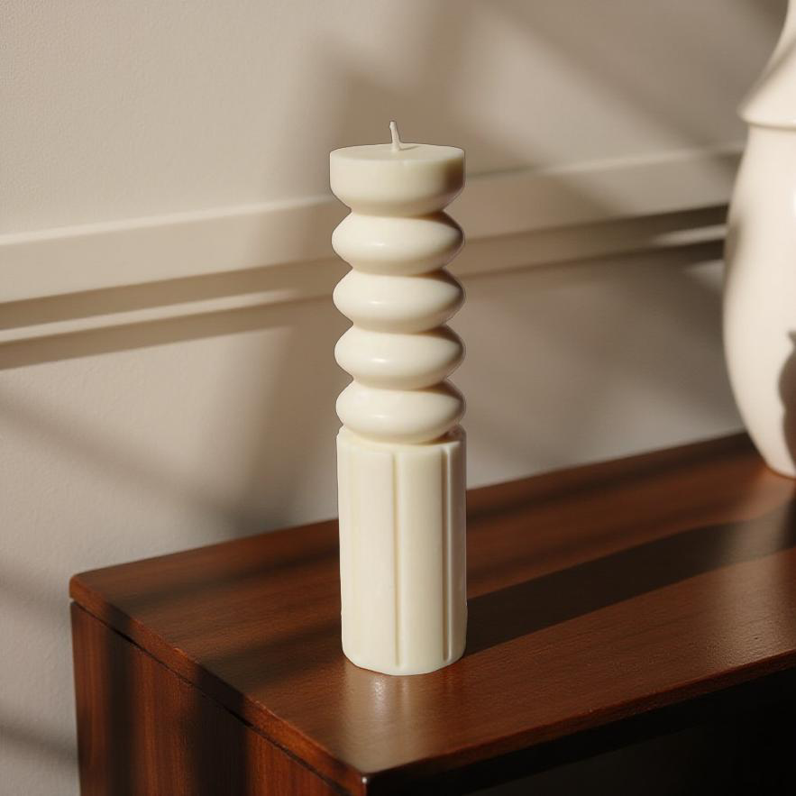 Handmade Ripple Pillar decorative candle by House of Wick, unscented soy wax sculptural pillar displayed on a wooden console table in a minimalist modern interior.