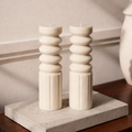 Pair of Ripple Pillar sculptural soy wax candles by House of Wick, modern minimalist decorative pillar candles styled on a stone tray for coffee table or shelf décor.