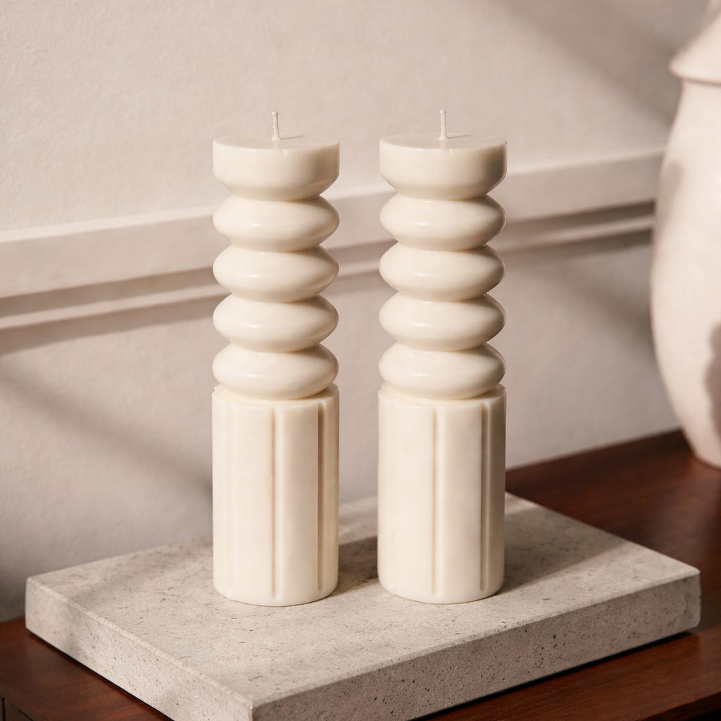 Pair of Ripple Pillar sculptural soy wax candles by House of Wick, modern minimalist decorative pillar candles styled on a stone tray for coffee table or shelf décor.
