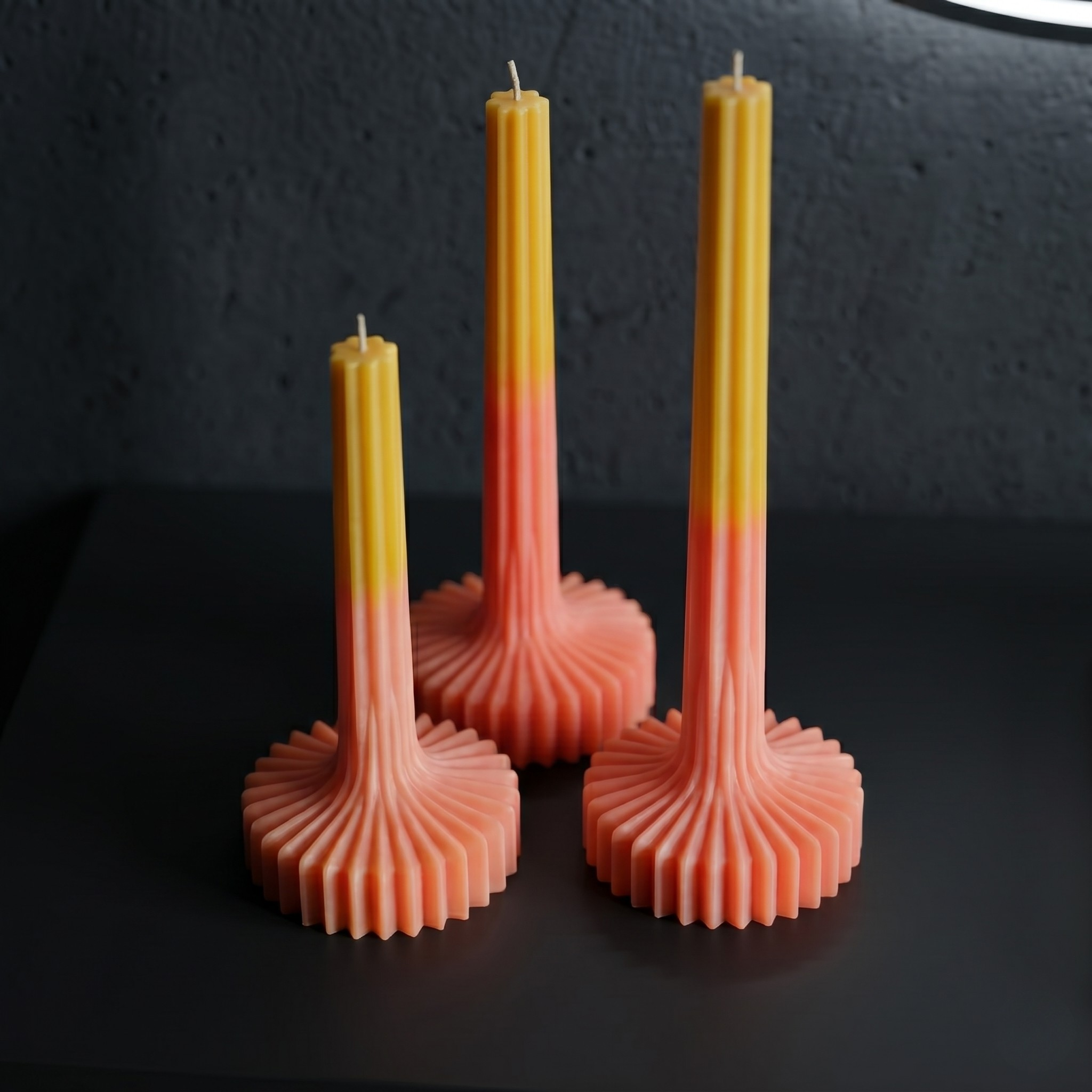 Sculptural taper candles on a glass table in an industrial loft setting by House of Wick
