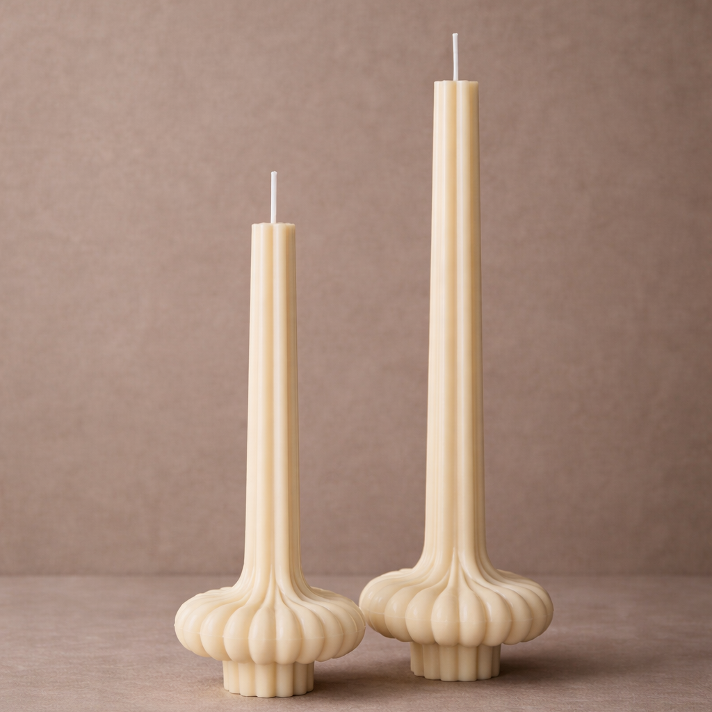 Modern sculptural vase pillar candles made from natural soy wax with a fluted base design displayed against a warm neutral background.