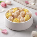 Tulip Bloom candle by House of Wick — yellow and cream hand-sculpted tulips in a smooth round eco resin bowl