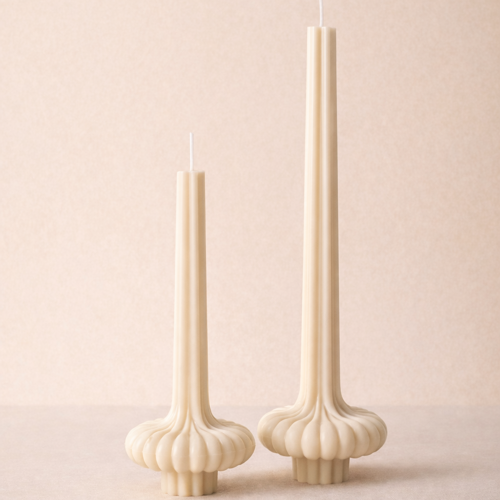 Hand-poured vase pillar candle in two sizes featuring a sculptural fluted base and tall elegant silhouette in neutral soy wax.