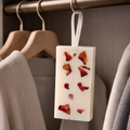 Natural floral wax sachet with dried rose petals hanging in modern wooden closet