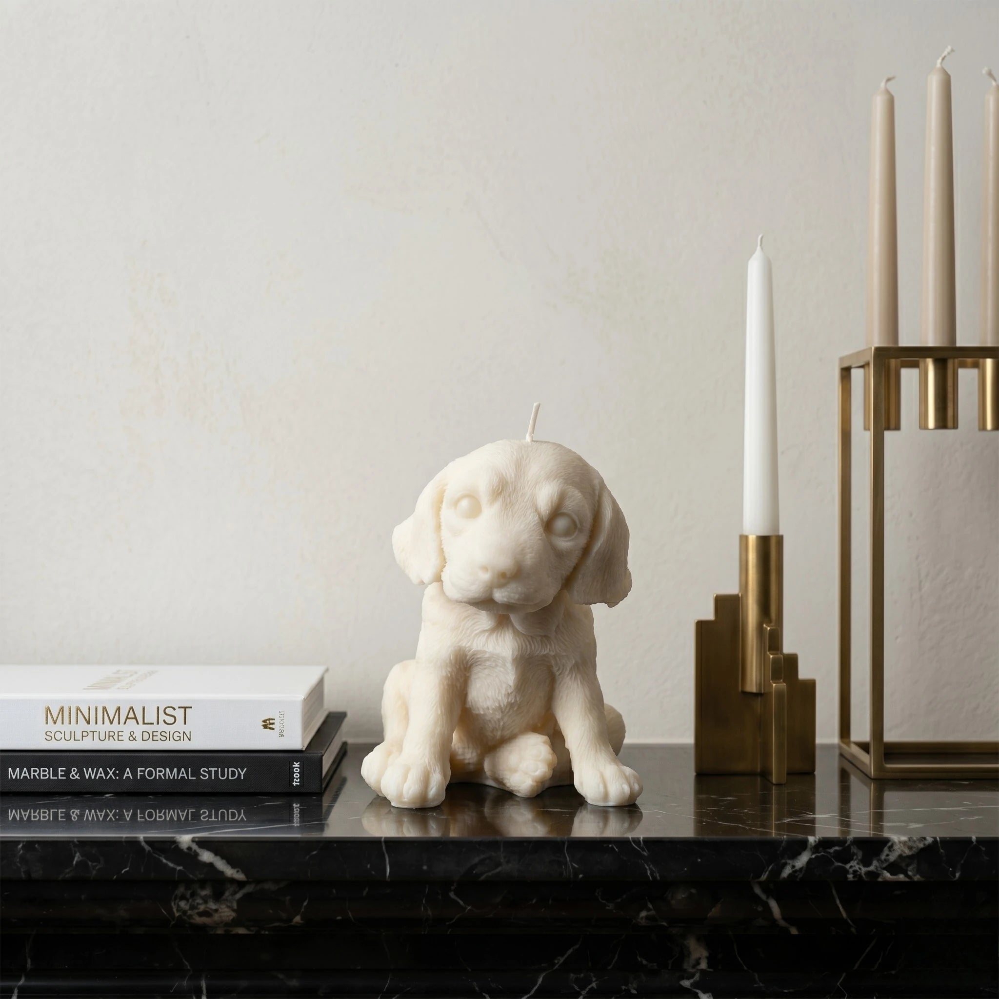 White beagle puppy candle lifestyle on marble shelf with books
