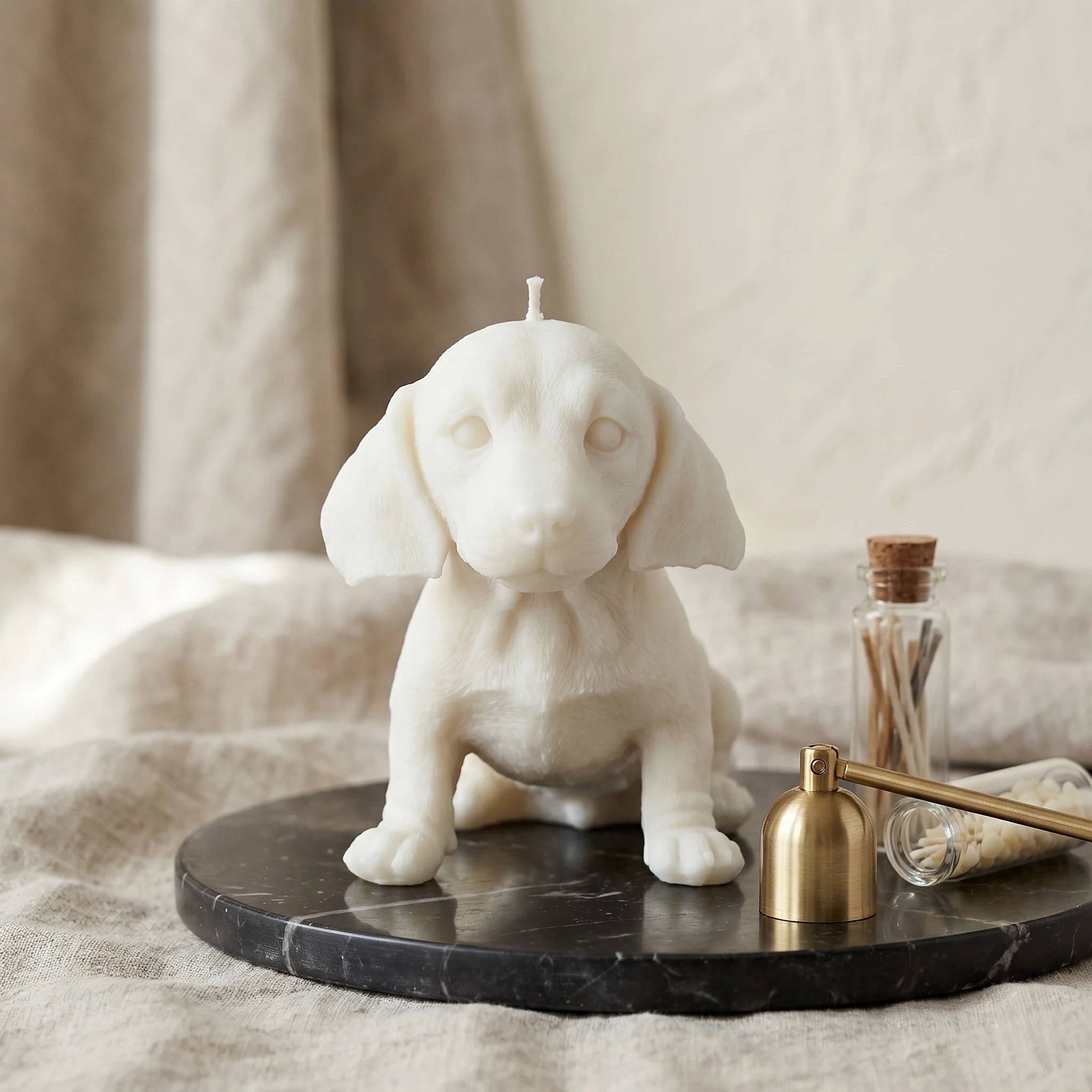 White dachshund puppy candle handmade beeswax sculptural product shot
