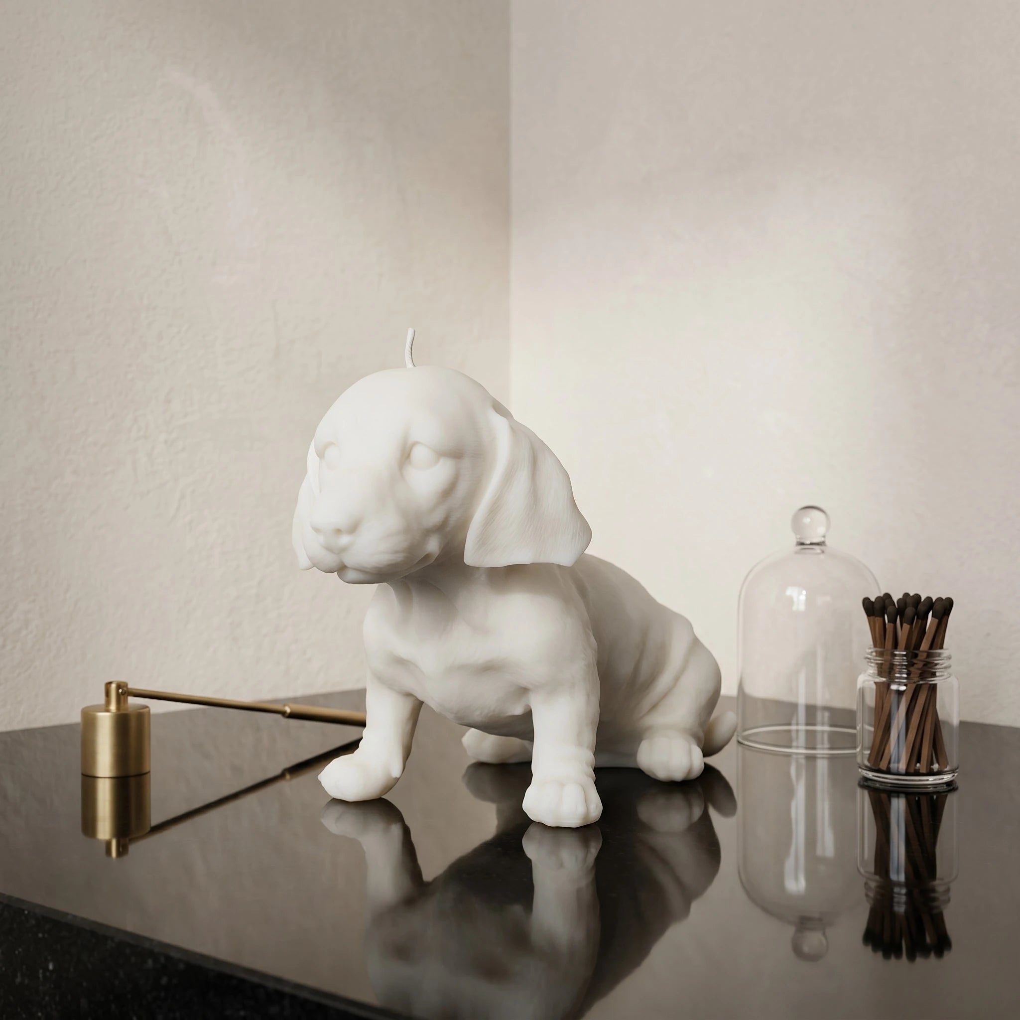White dachshund puppy candle on dark table with dome jar product shot