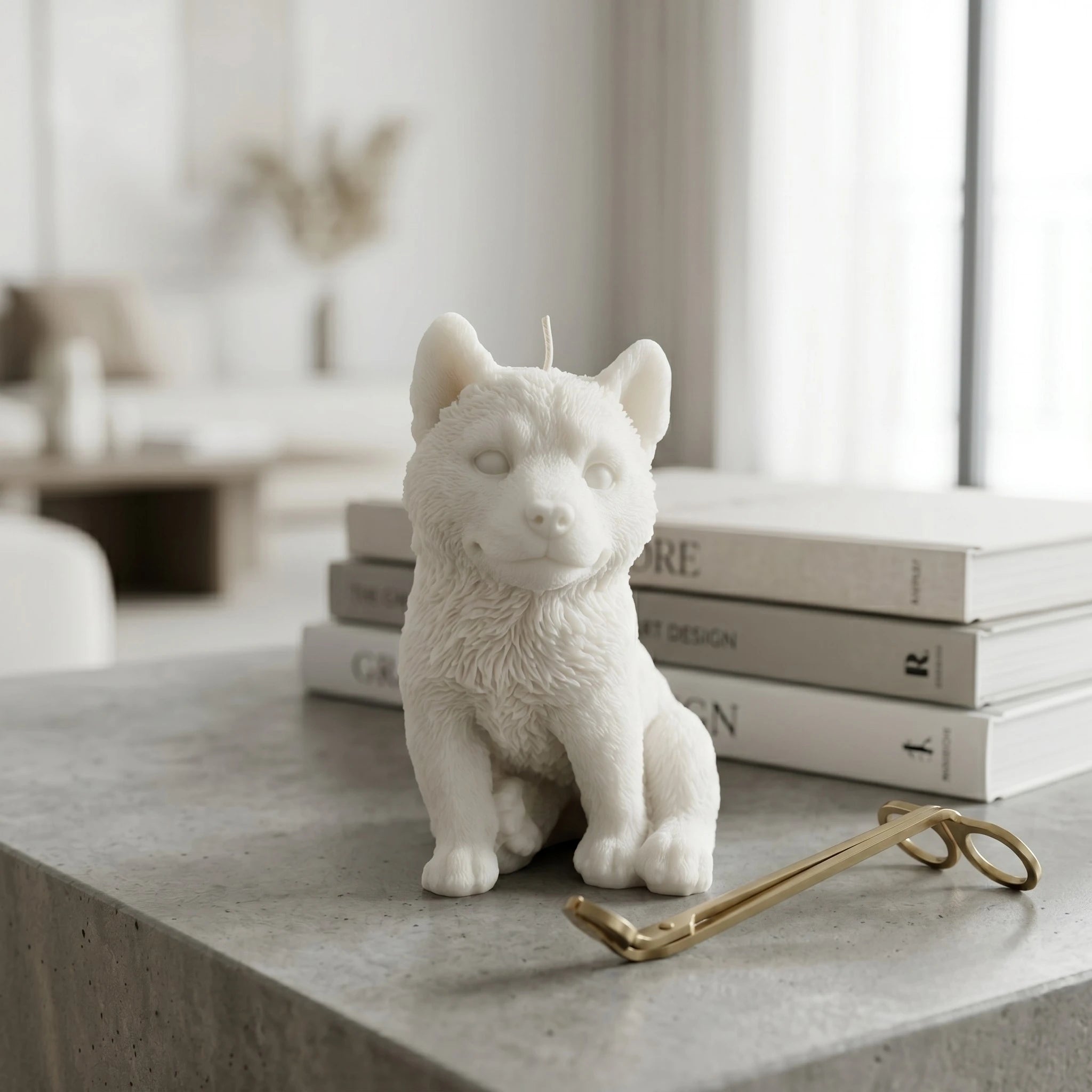 White husky puppy candle by House of Wick on a marble kitchen counter.