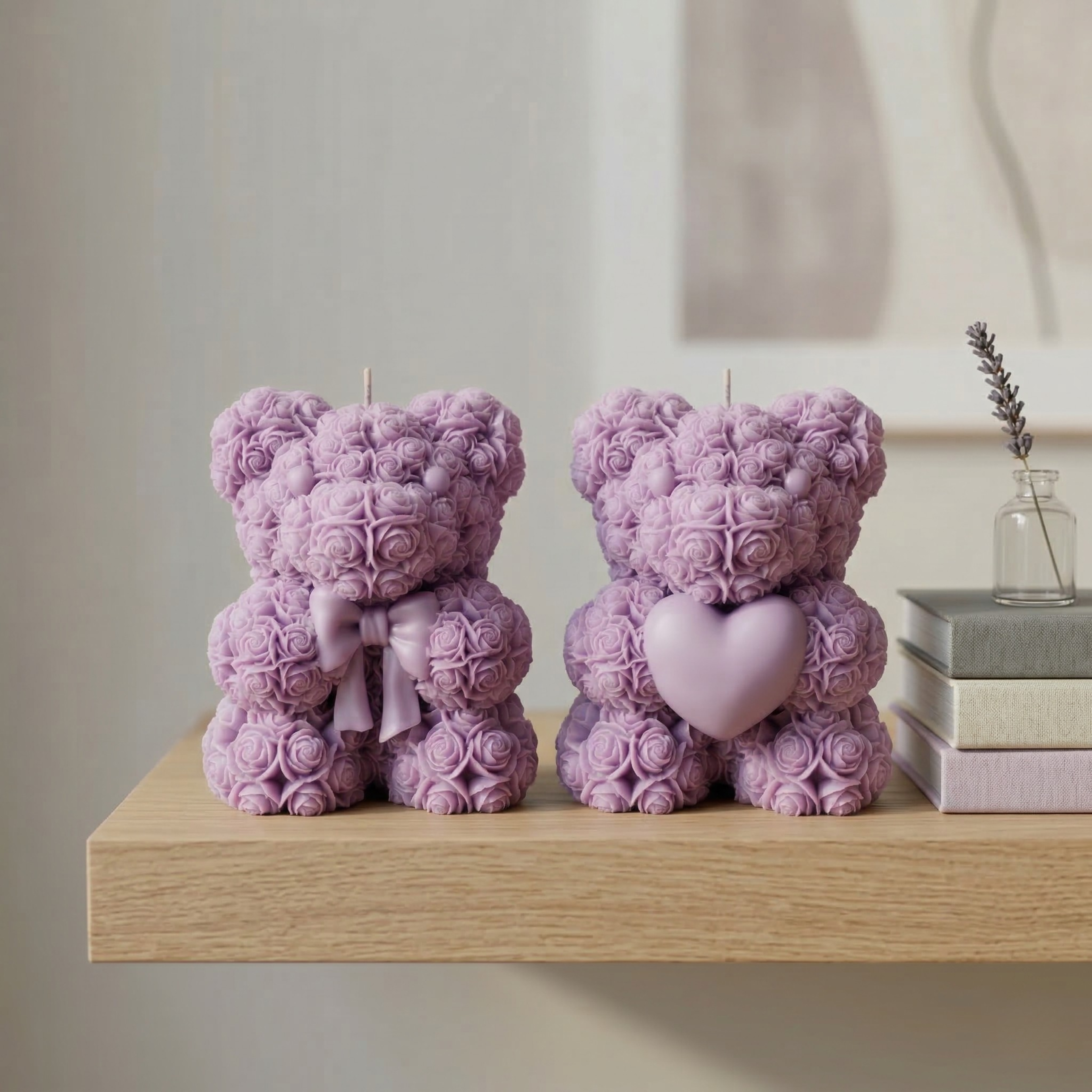 Set of two purple teddy bear candles with heart and bow placed on a wooden shelf with minimal decor